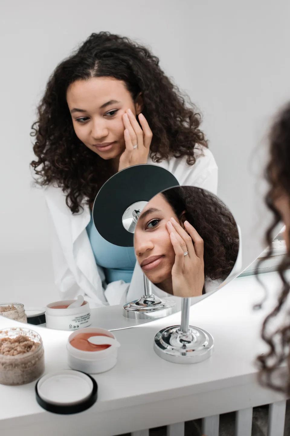 Woman checking her facial skin in a mirror